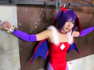 Pretty Asian babe in a sexy costume gets schooled in bondage