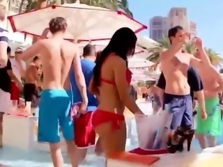 Striking babe in a sexy red bikini enjoys the warm weather
