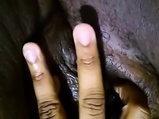 Lustful dark skinned woman sends her fingers pleasing her j