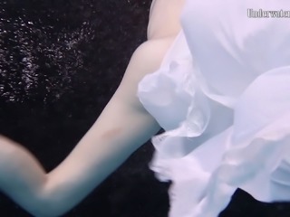 Sweet and special sexy redhead babe in white dress under water